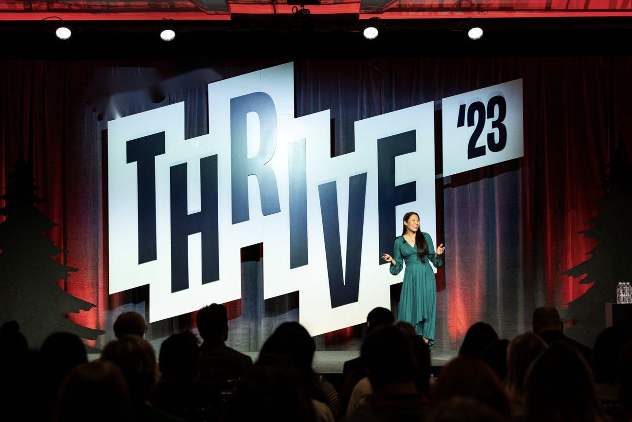Jennie giving a keynote on a conference stage